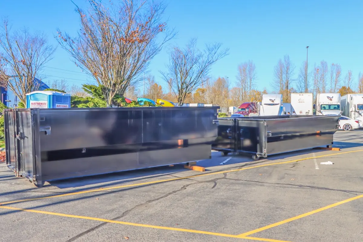 Professional dumpster rental service with roll-off container on residential driveway in Kalamazoo